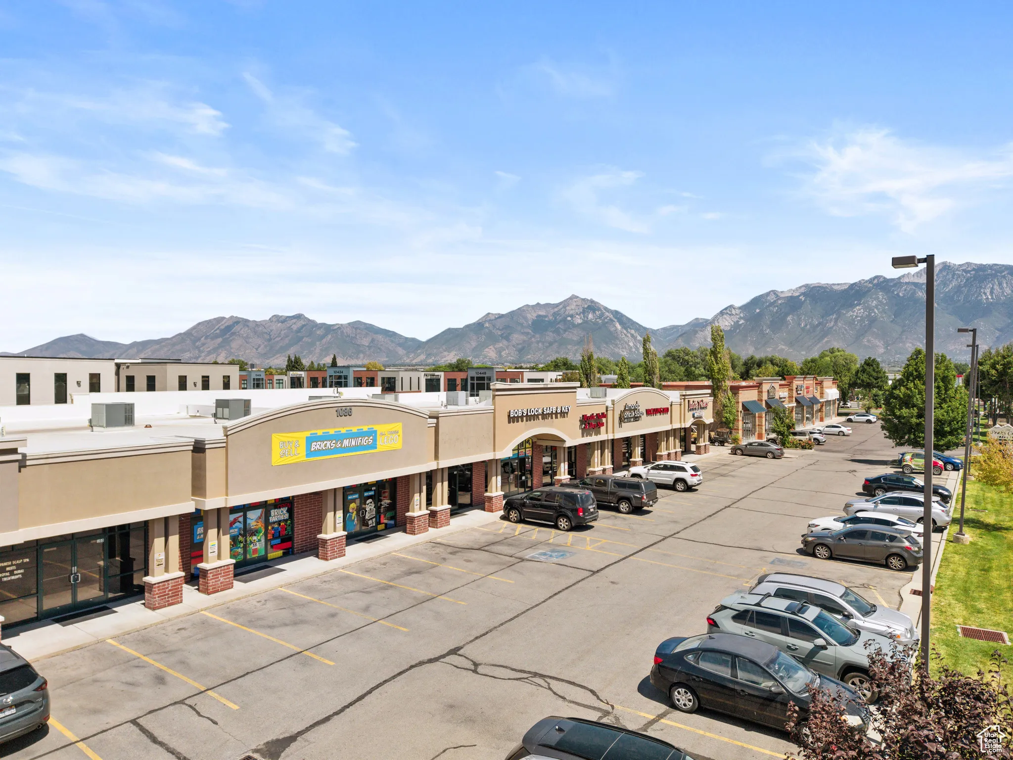 View of commercial location with a mountain view and uncovered parking