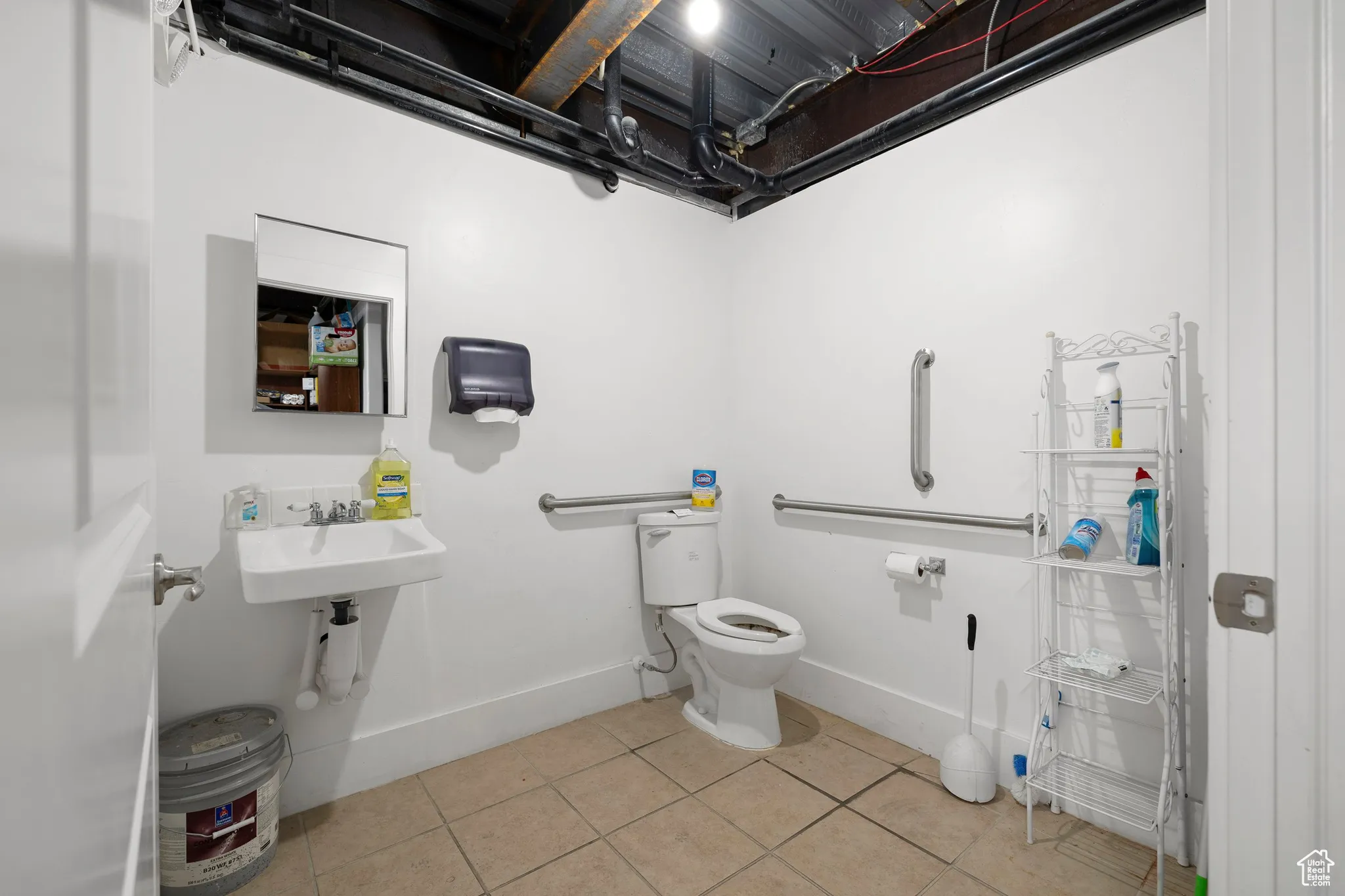 Half bathroom featuring baseboards and light tile patterned floors