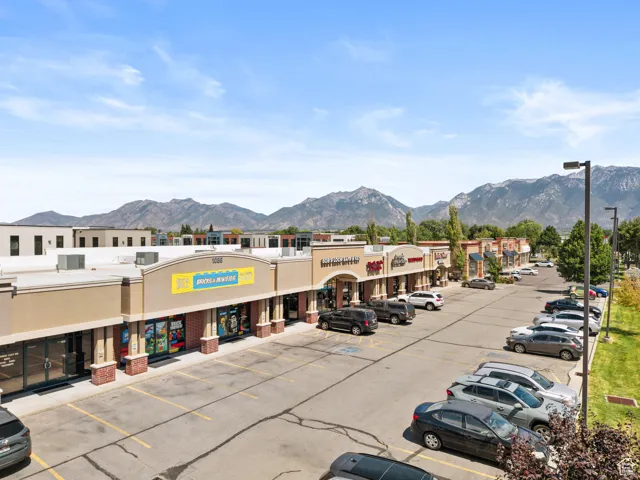 View of commercial location with a mountain view and uncovered parking
