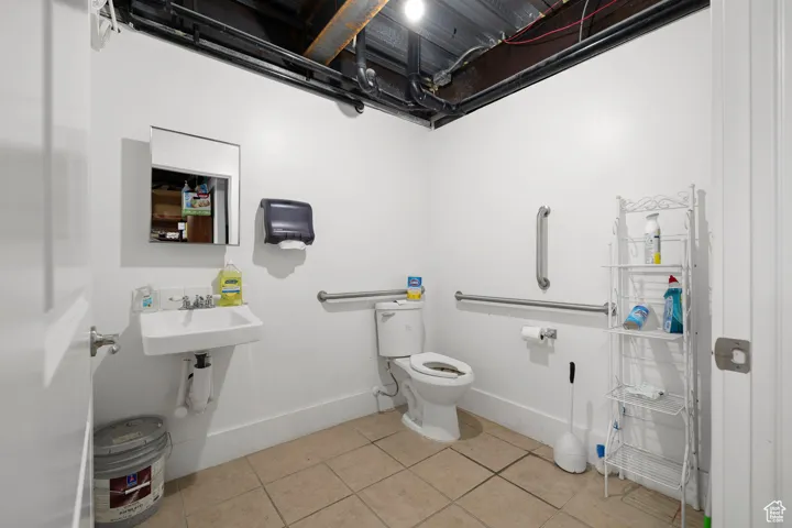 Half bathroom featuring baseboards and light tile patterned floors