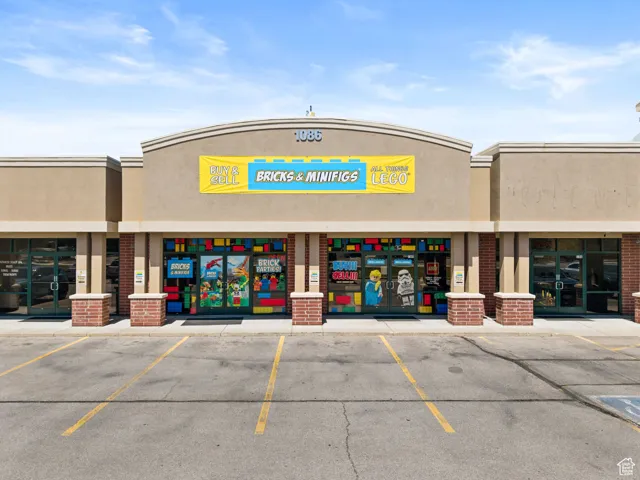 View of building exterior featuring uncovered parking