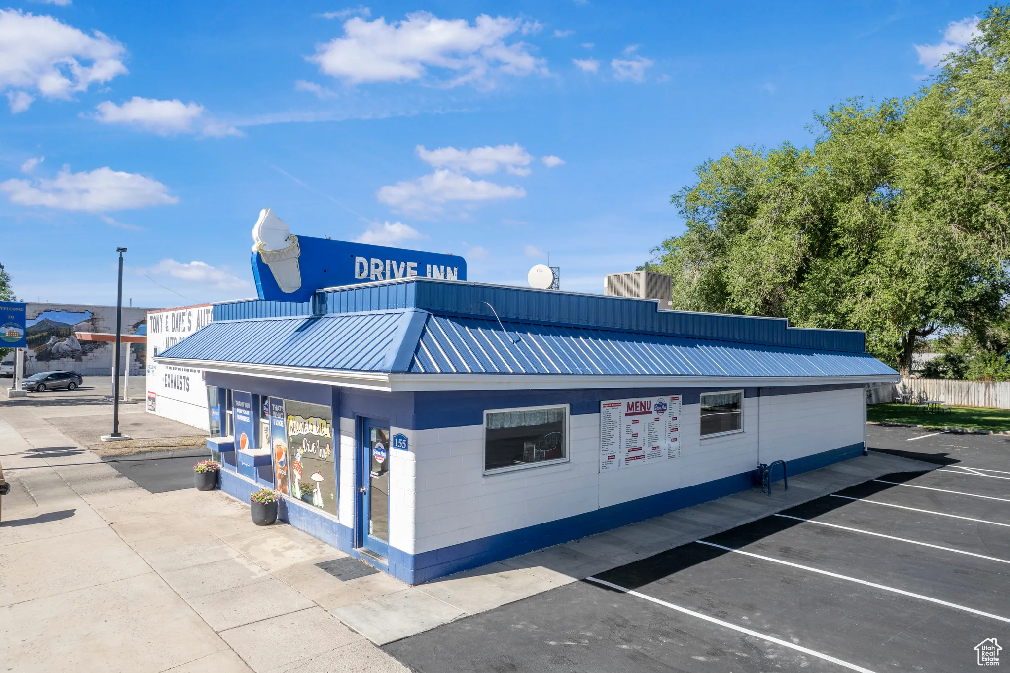 View of commercial property featuring uncovered parking