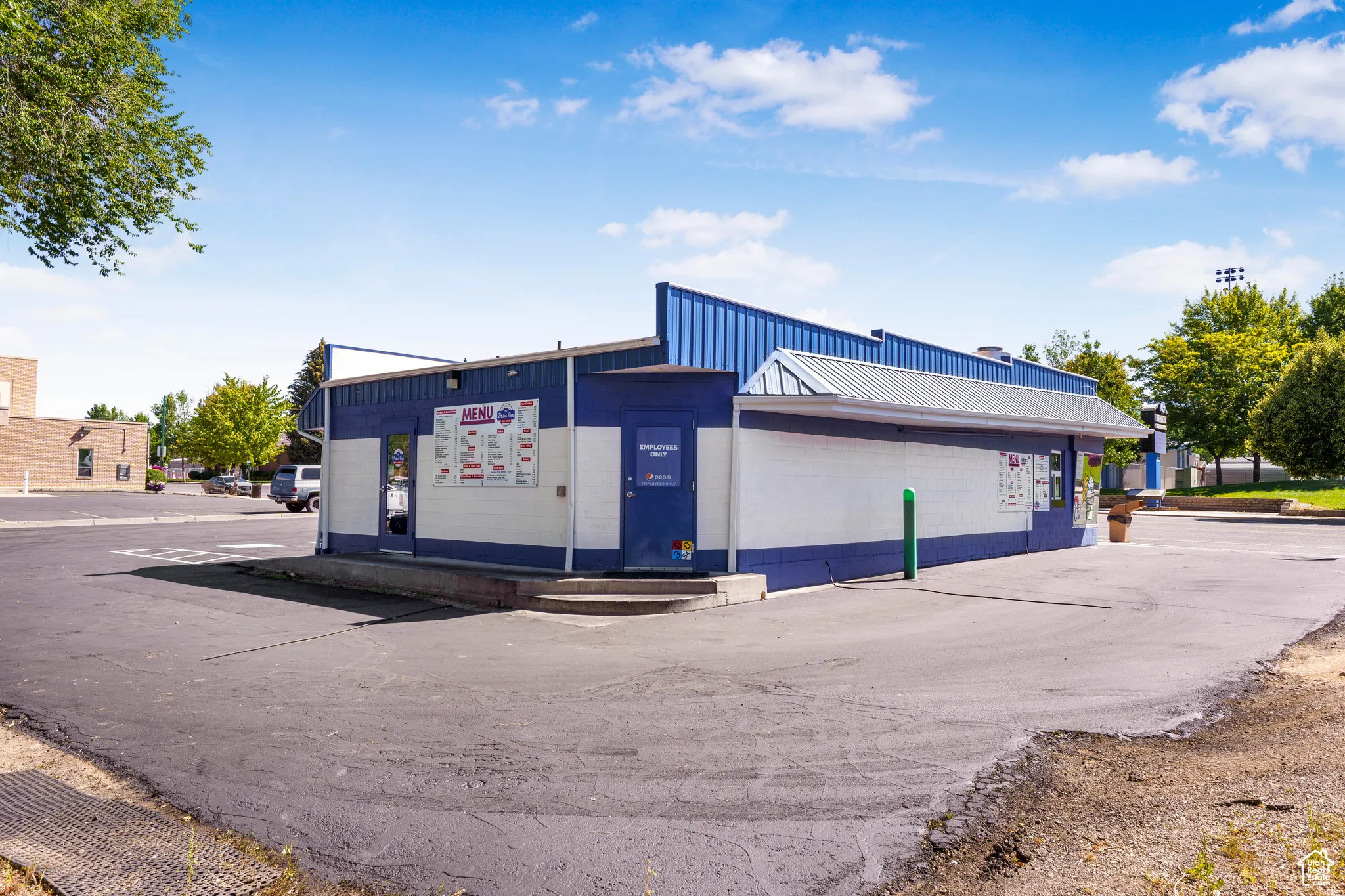 View of commercial property with uncovered parking
