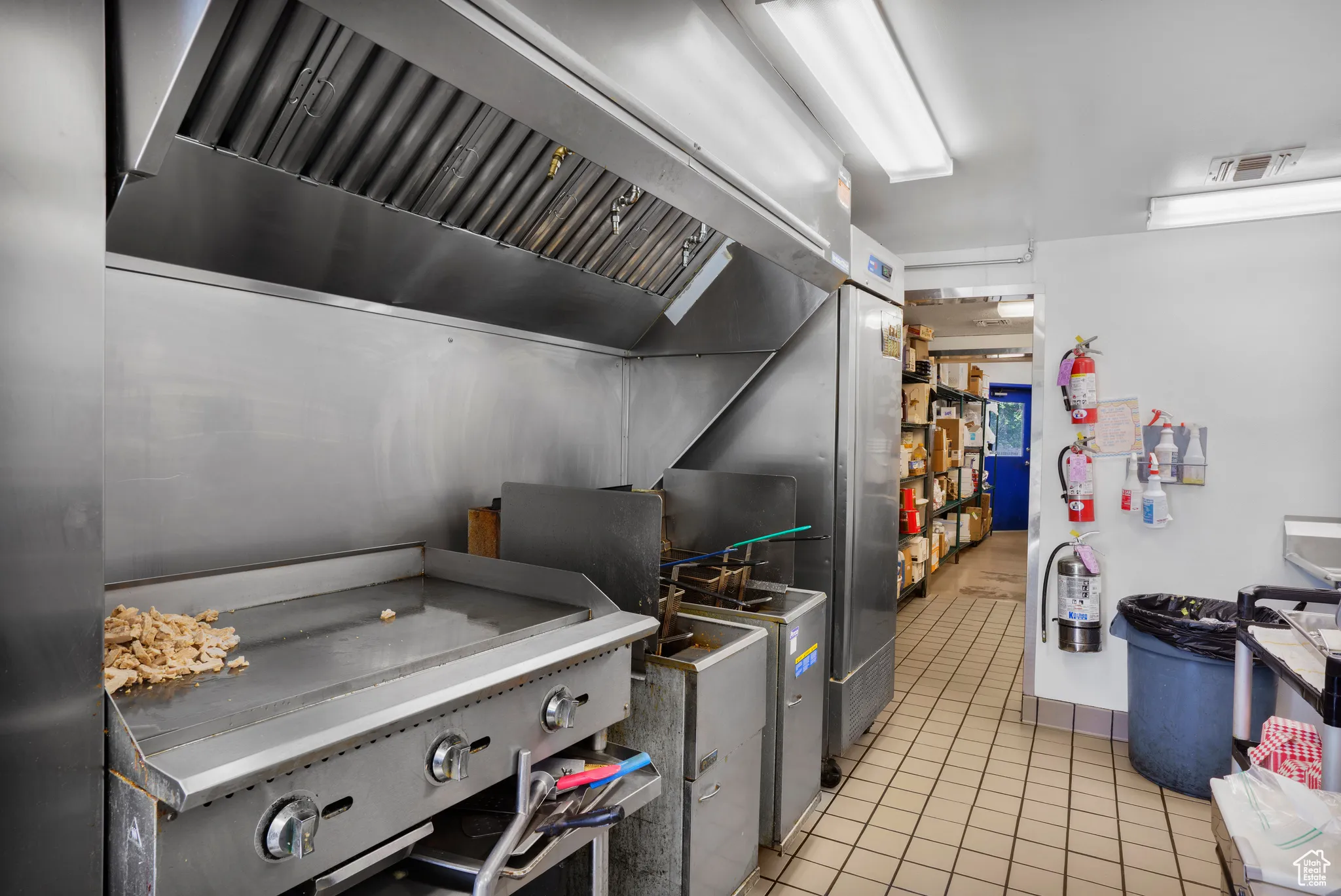 Kitchen with premium range hood and light tile patterned flooring