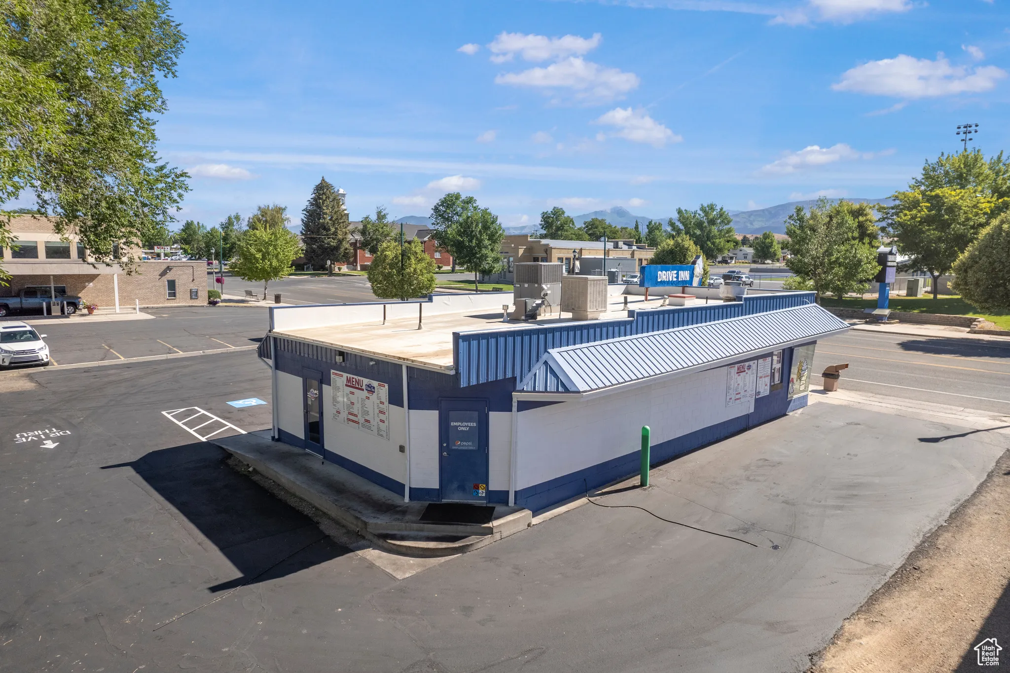 View of asphalt road with curbs and a mountain view