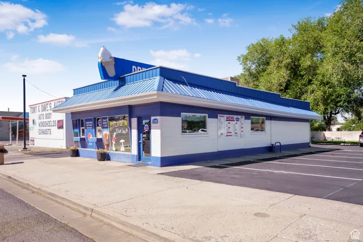 View of commercial property featuring uncovered parking