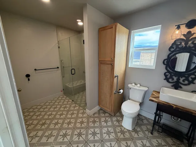 Full bathroom featuring a shower stall, light floors, and recessed lighting