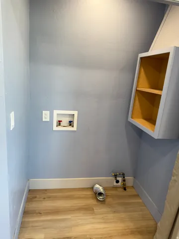 Laundry room with light wood-style floors and hookup for a washing machine