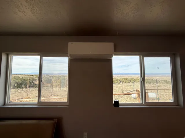 Empty room featuring a mini split for heating / cooling, a textured ceiling, and a mountain view