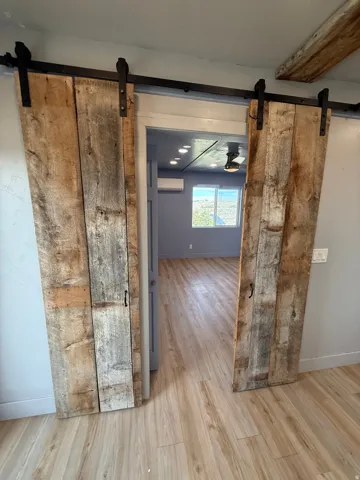 Hall featuring a barn door and light wood-style flooring