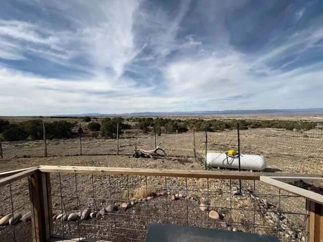 View of yard with a view of countryside and a balcony