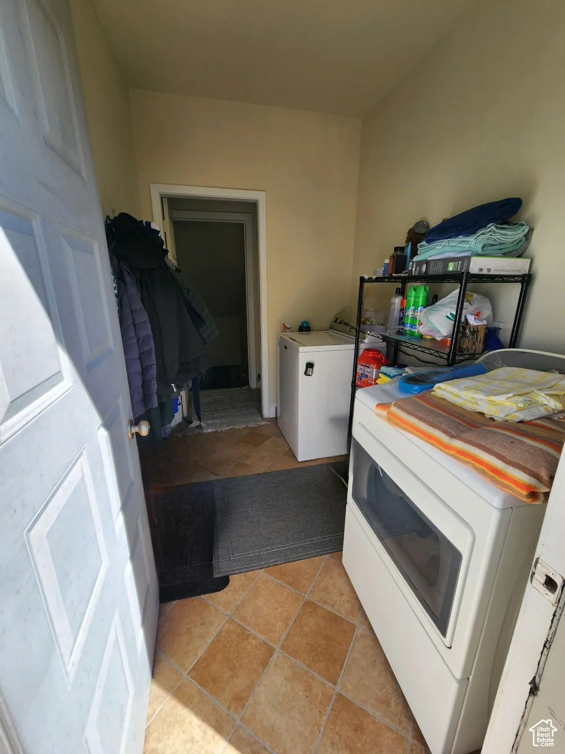Laundry area with light tile patterned floors and washer and dryer