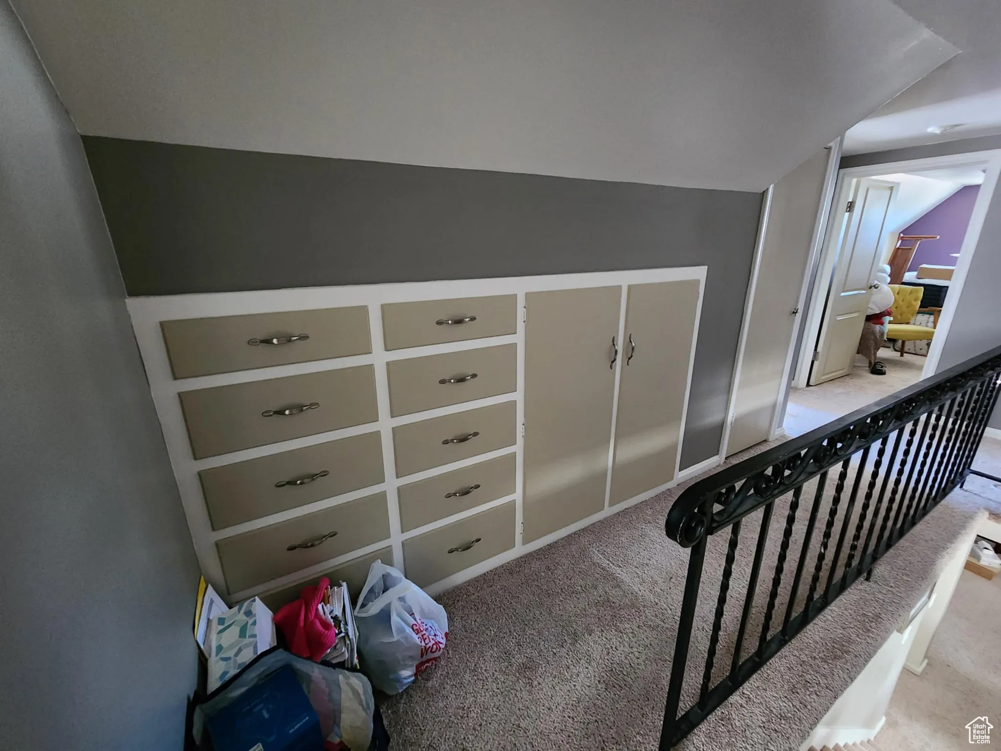 Stairway with carpet floors and vaulted ceiling