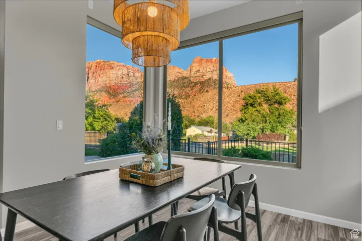 Dining room with a mountain view and light wood-type flooring