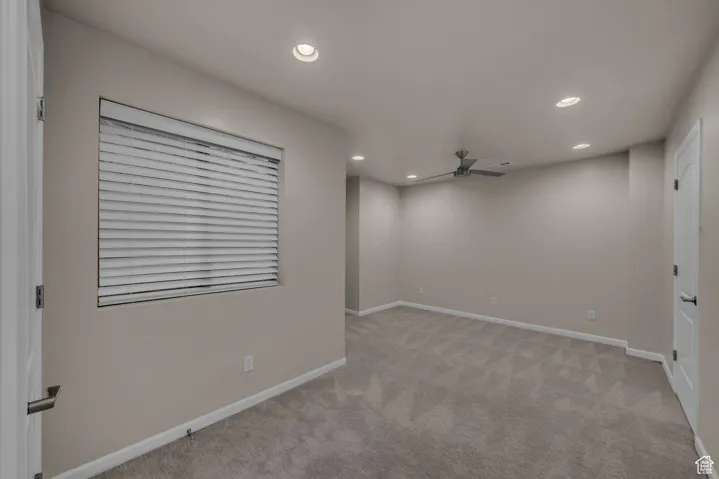 Empty room with recessed lighting, light colored carpet, and a ceiling fan