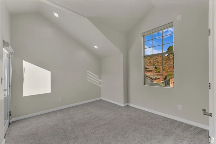 Bonus room featuring recessed lighting, light colored carpet, and high vaulted ceiling