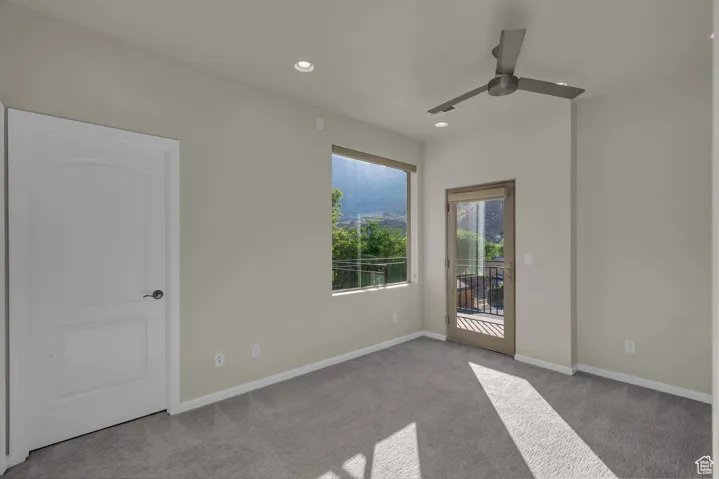 Empty room featuring carpet floors, recessed lighting, and ceiling fan