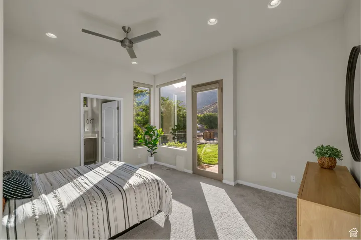Carpeted bedroom with recessed lighting, access to outside, ceiling fan, and ensuite bathroom