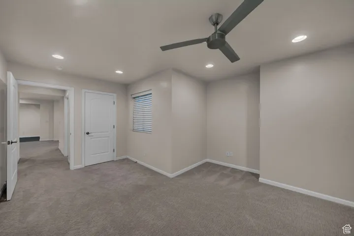 Empty room with light colored carpet, recessed lighting, and ceiling fan