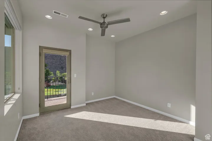 Unfurnished room featuring light colored carpet, recessed lighting, and a ceiling fan