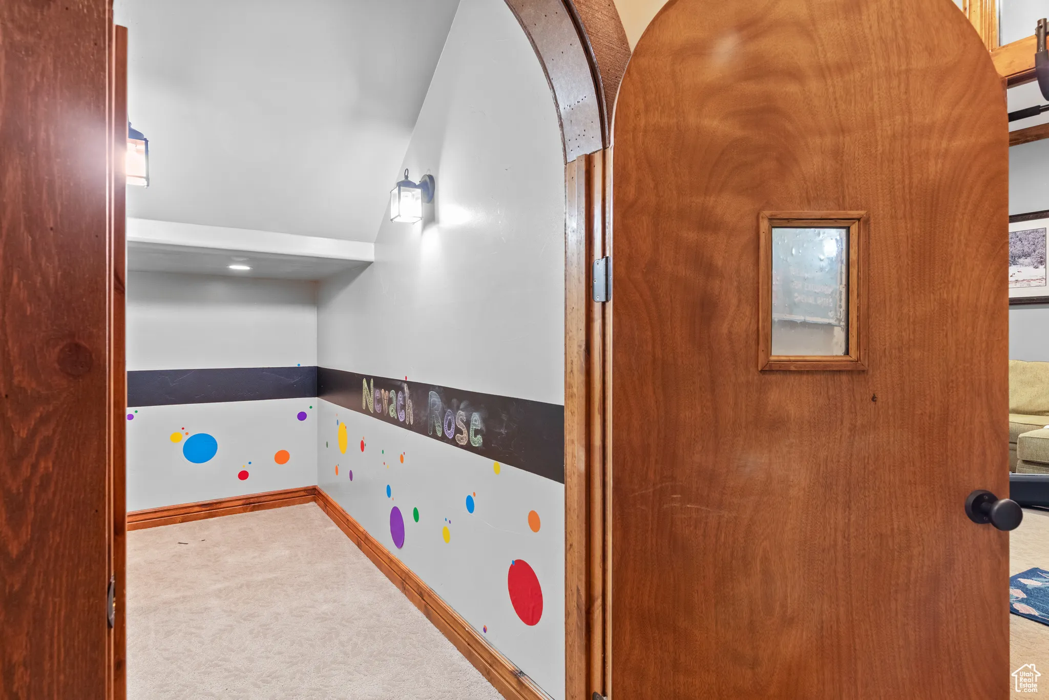 Recreation room featuring carpet floors and arched walkways