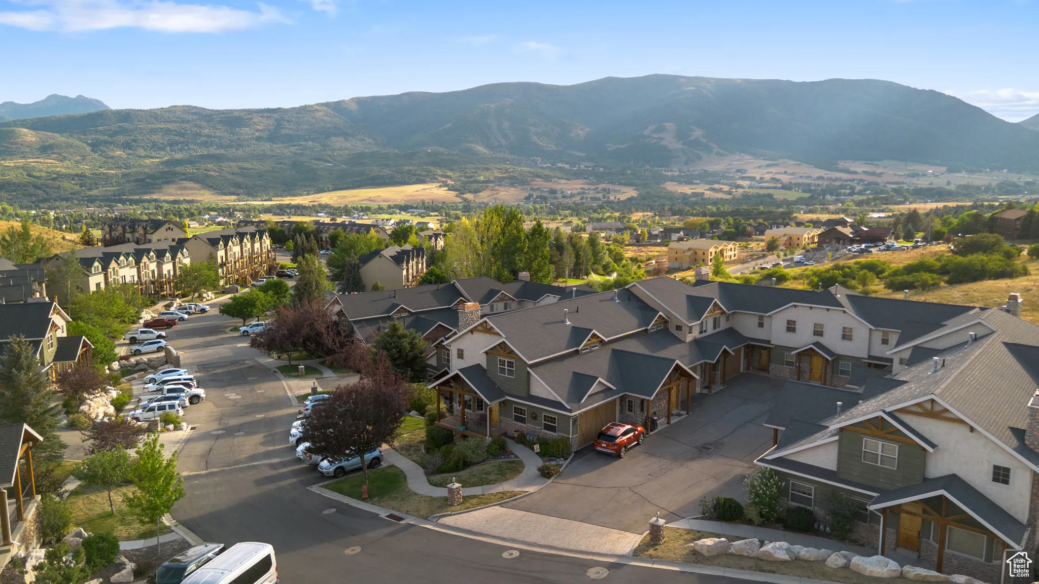 View of property location featuring mountains and nearby suburban area