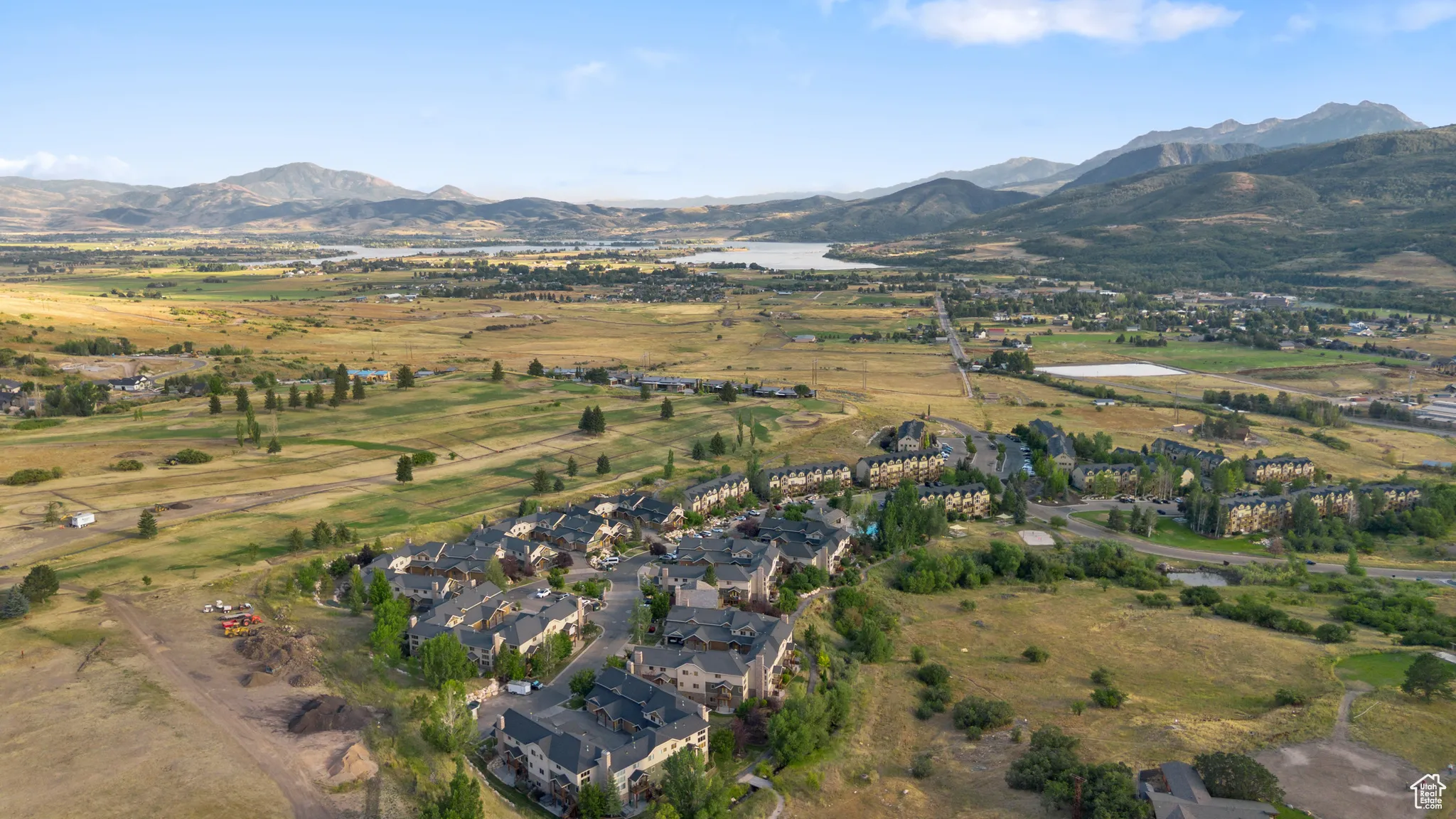 Aerial overview of property's location featuring a water and mountain view and nearby suburban area