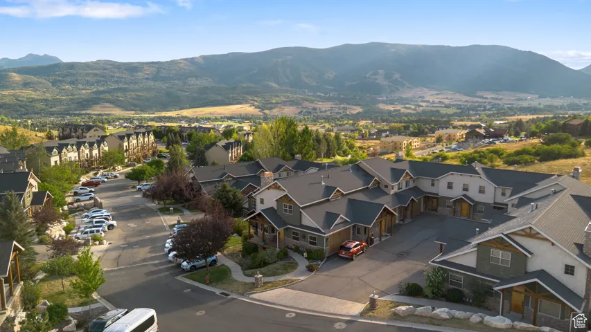 View of property location featuring mountains and nearby suburban area