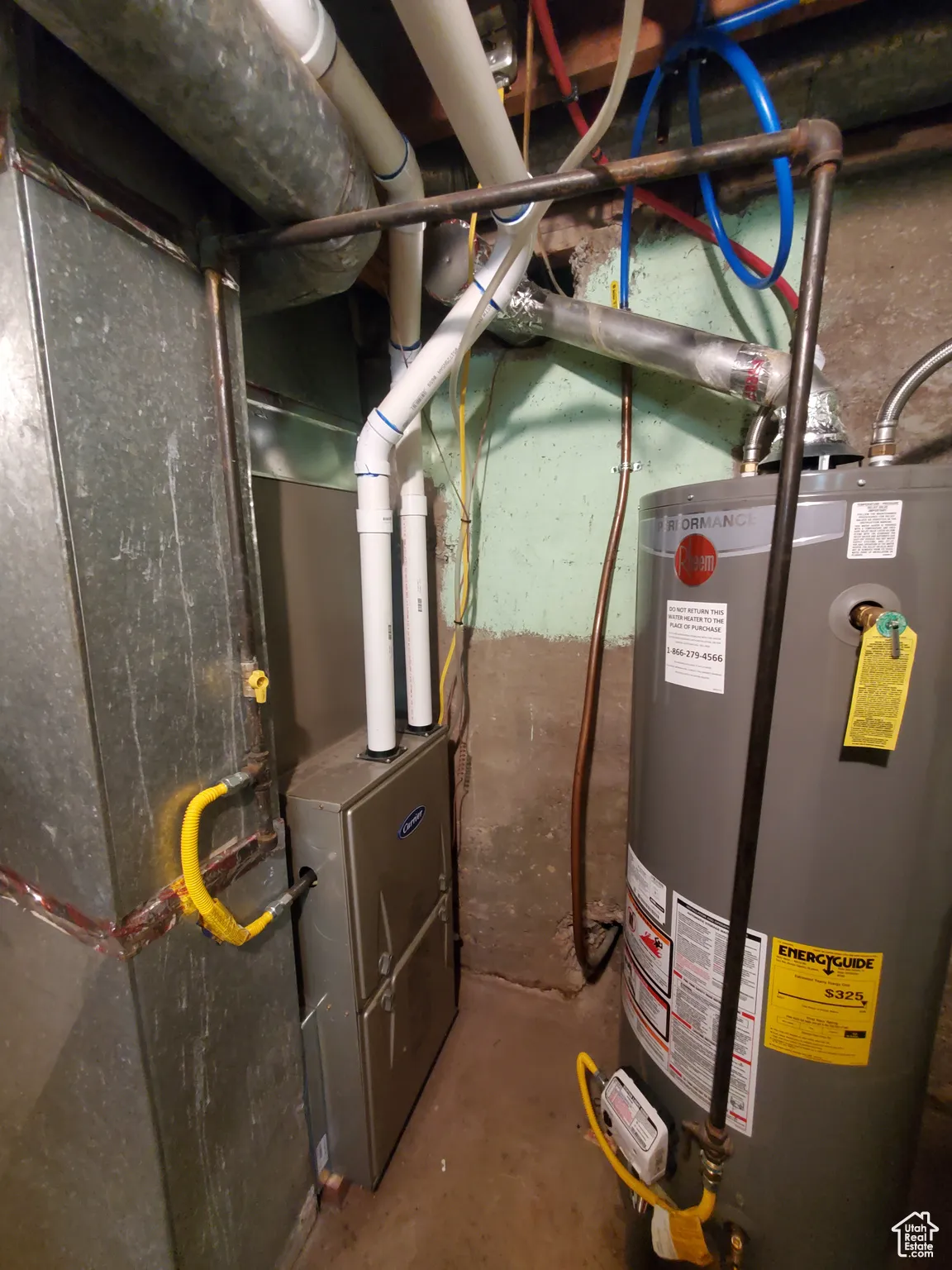 Utility room featuring gas water heater and heating unit