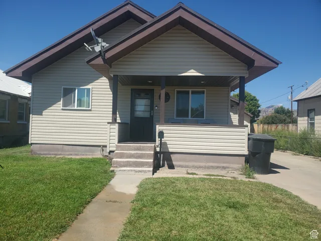 Bungalow featuring a porch and a front yard