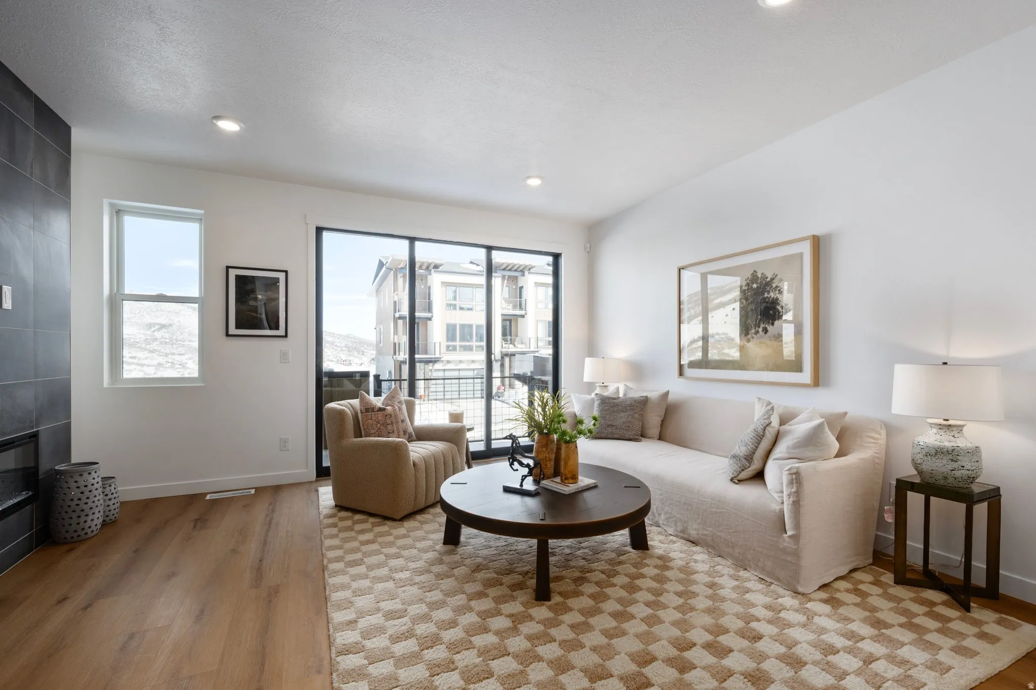 Living area featuring healthy amount of natural light, light wood-type flooring, and recessed lighting