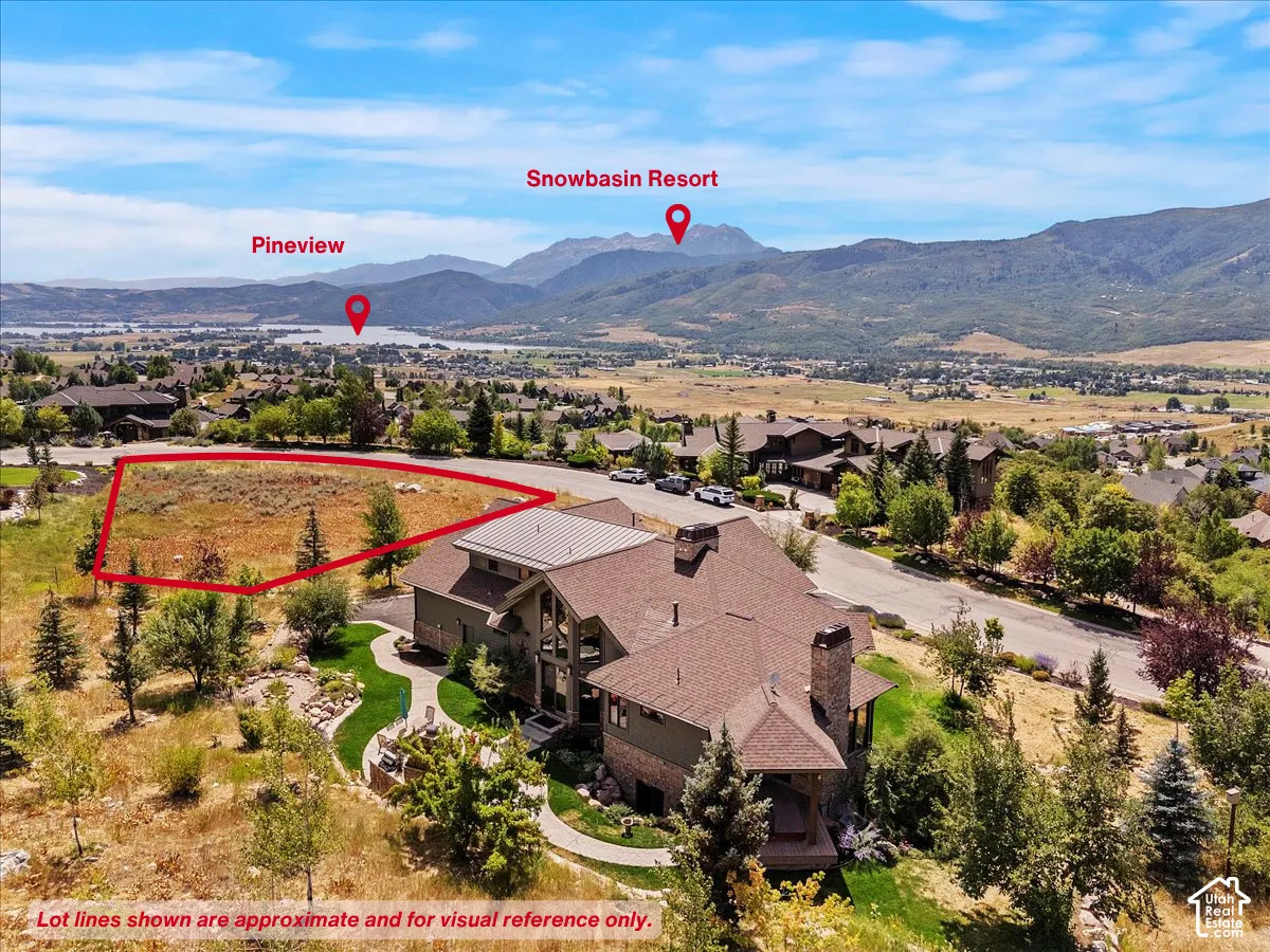 Aerial perspective of suburban area with a mountainous background and property parcel outlined