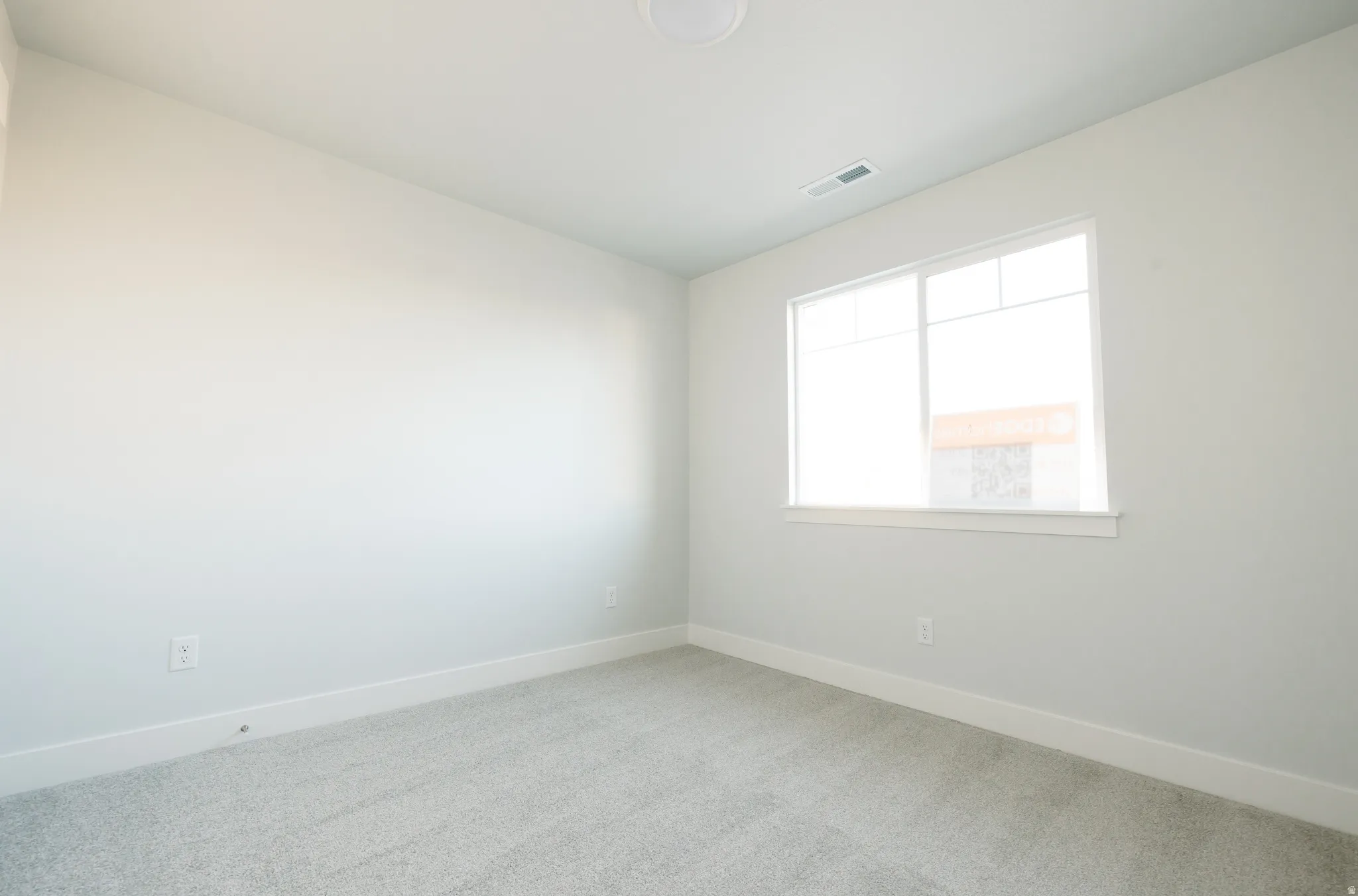 Spare room featuring baseboards and carpet flooring
