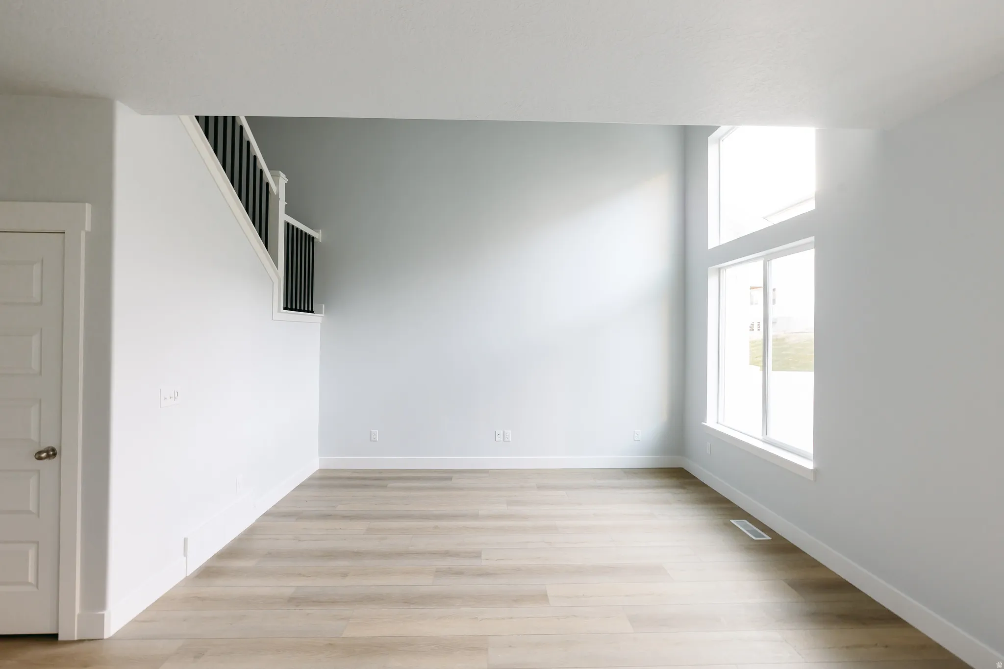 Spare room with light wood-style flooring and baseboards