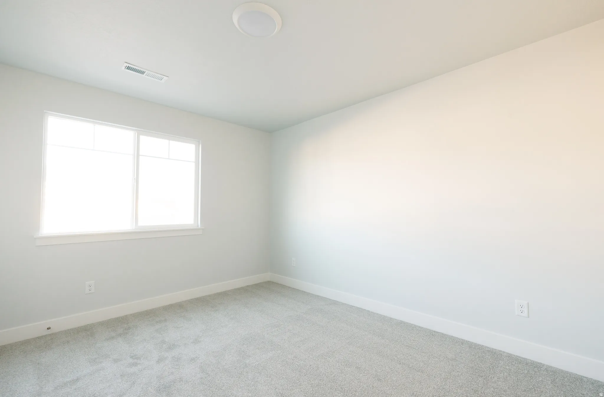 Spare room featuring baseboards and carpet floors