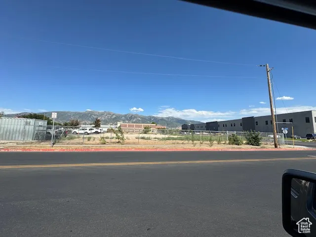 View of asphalt road featuring curbs