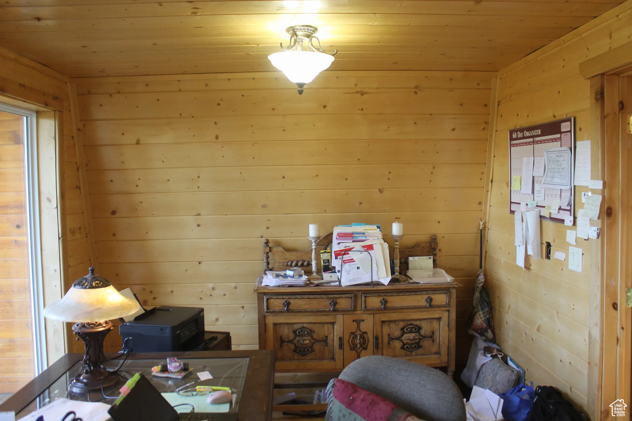Living area featuring wooden walls and wood ceiling