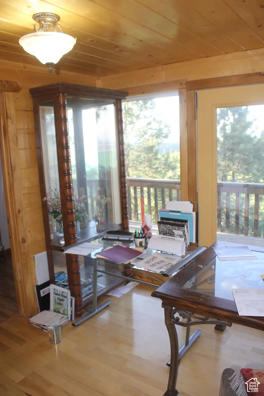 Dining space featuring wooden ceiling, wood finished floors, and wooden walls