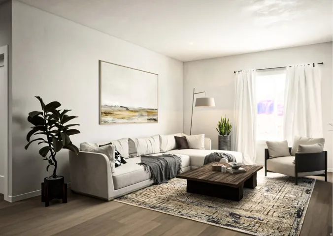 Spacious living area featuring light-toned walls, recessed lighting, and wood-finish flooring