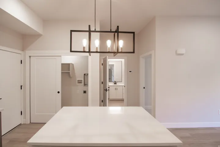 Kitchen featuring light wood-type flooring, decorative light fixtures, and a chandelier