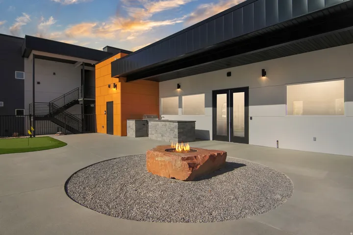 View of patio featuring a fire pit, a putting area, and area for grilling