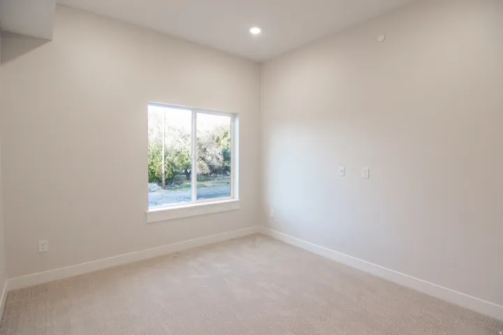 Empty room featuring light colored carpet and recessed lighting