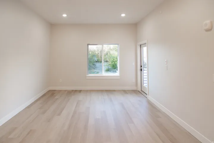 Empty room featuring light wood finished floors and recessed lighting