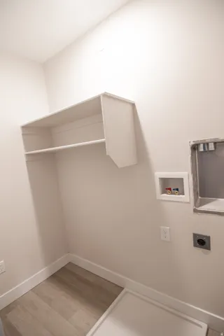 Washroom featuring light wood-style flooring, washer hookup, and electric dryer hookup