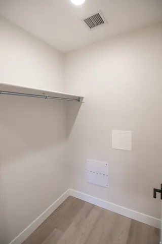 Spacious closet featuring light wood-type flooring