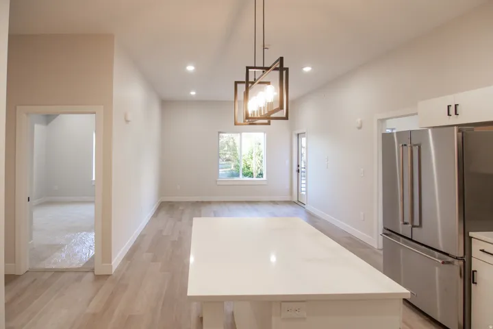 Unfurnished dining area with light wood-style flooring, recessed lighting, and a chandelier