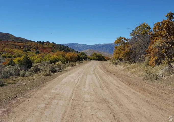 View of dirt / gravel road featuring a mountain view