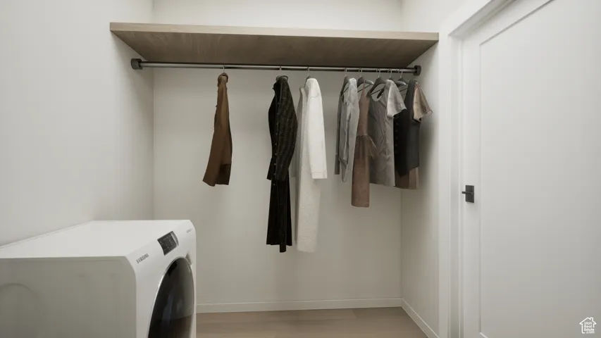 Washroom featuring washer / dryer and light wood-style flooring