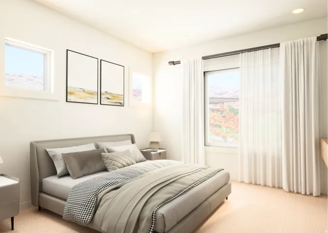 Bright room featuring light-toned carpeting and recessed ceiling lights