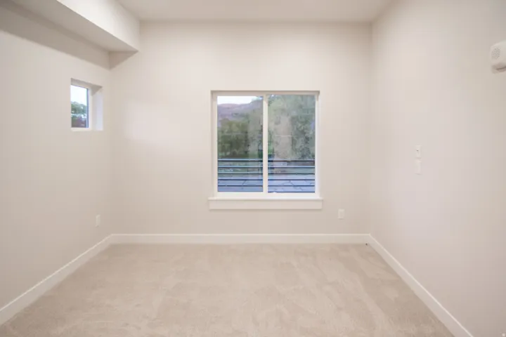 Spare room featuring light carpet and plenty of natural light